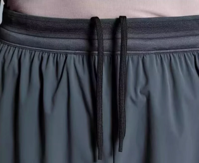 Dark sports shorts with a breathable knitted waistband and drawcord