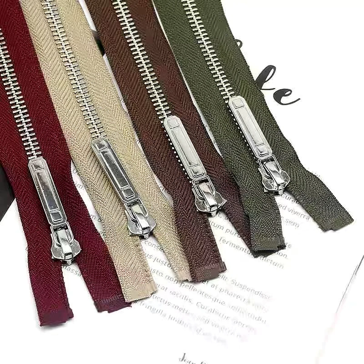 Metal zippers with silver-tone teeth and coordinated sliders