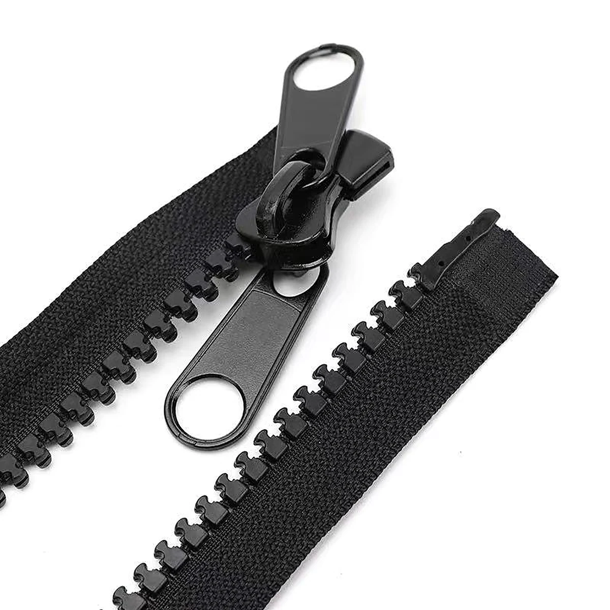 Close-up of black plastic molded zipper teeth and sliders